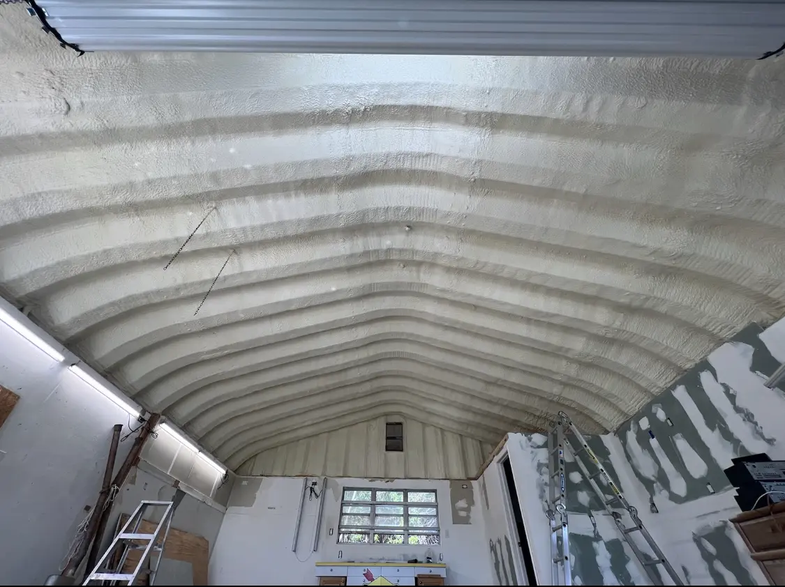 Spray polyurethane foam applied to the underside of a metal roof deck in Glennville